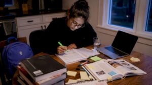 Student planning college classes at dorm desk