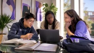 Students planning classes together at campus lounge