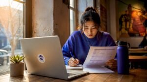 Female student planning classes at campus library table