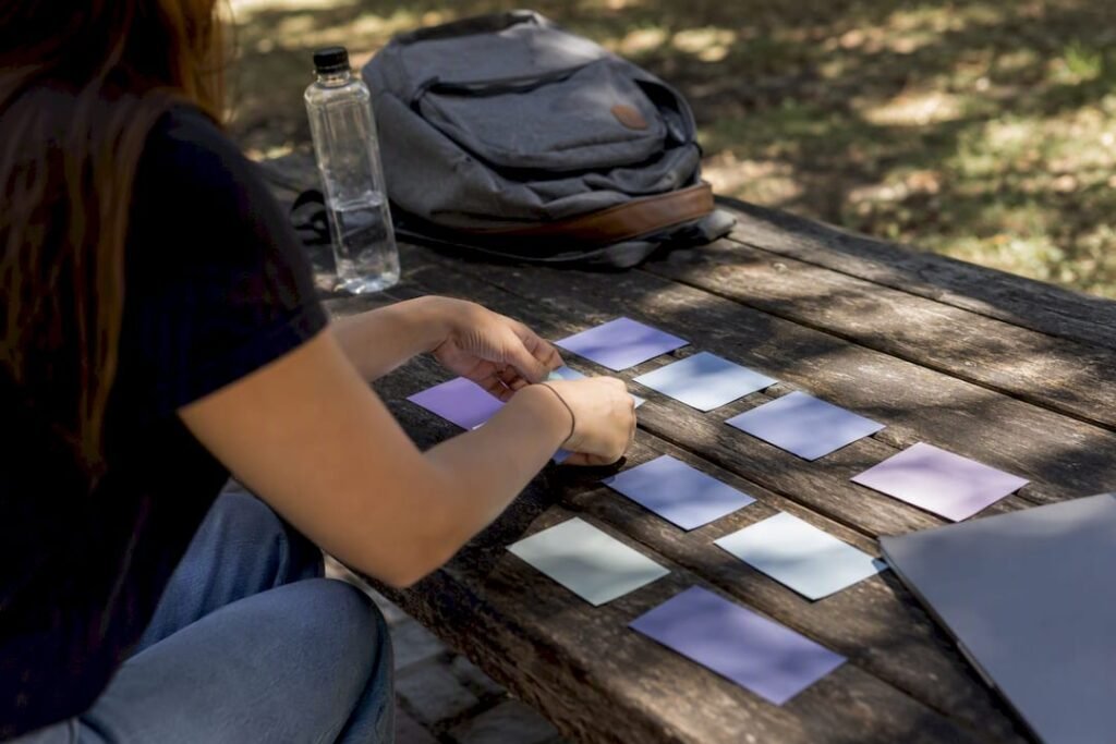 Hands arranging college course schedule cards
