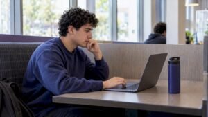 Student comparing course options on laptop